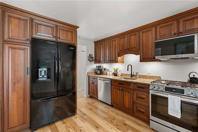 1214 Regency Dr, Mccandless, PA 15237 - kitchen featuring stainless steel appliances, light wood-style flooring, light stone counters, and brown cabinetry