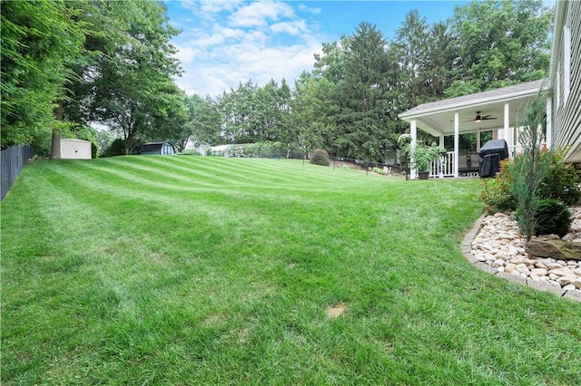 1214 Regency Dr, Mccandless, PA 15237 - fenced backyard with a storage unit, ceiling fan, and view of scattered trees