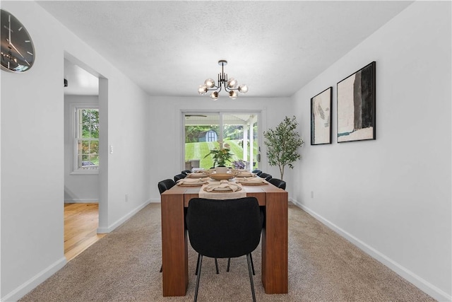 1214 Regency Dr, Mccandless, PA 15237 - dining space with light carpet, a chandelier, and a textured ceiling