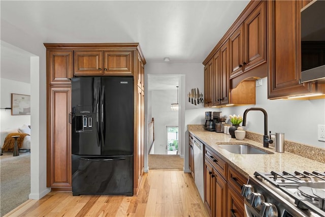 1214 Regency Dr, Mccandless, PA 15237 - kitchen featuring stainless steel appliances, light stone counters, brown cabinets, and light wood finished floors