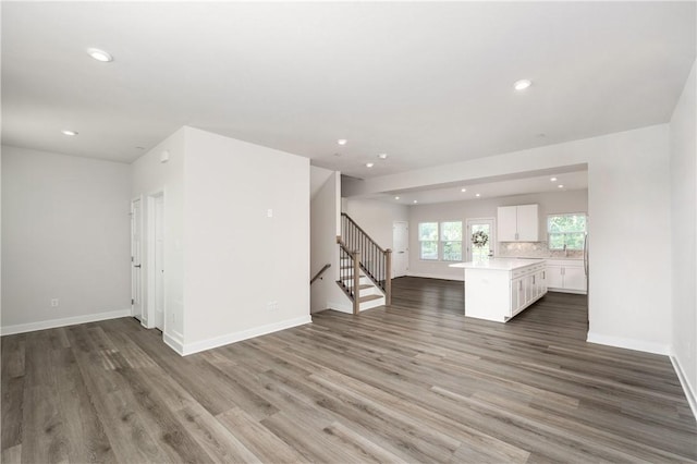 504 Nolan Cir, Cranberry Twp, PA 16066 - unfurnished living room featuring recessed lighting, wood finished floors, and stairs
