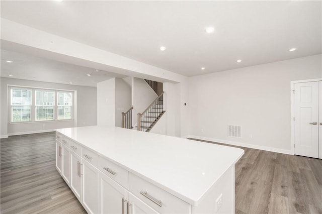 504 Nolan Cir, Cranberry Twp, PA 16066 - kitchen with open floor plan, light wood-type flooring, white cabinets, recessed lighting, and a center island
