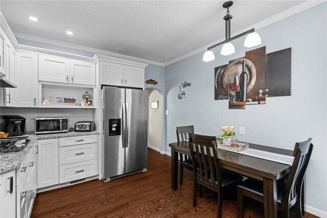 422 Ella St, Bloomfield, PA 15224 - kitchen featuring stainless steel appliances, ornamental molding, arched walkways, dark wood-style flooring, and white cabinetry