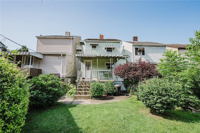 314 N 9th St, Apollo Boro, PA 15613 - rear view of house with a porch, a lawn, a chimney, and stairs