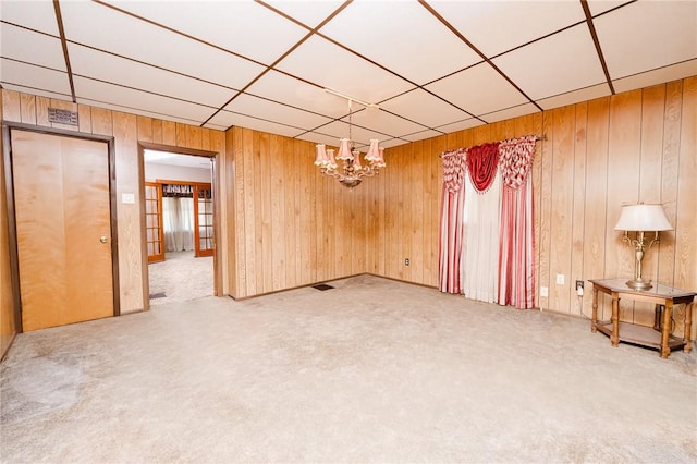 314 N 9th St, Apollo Boro, PA 15613 - spare room with a chandelier, carpet floors, wood walls, and a paneled ceiling