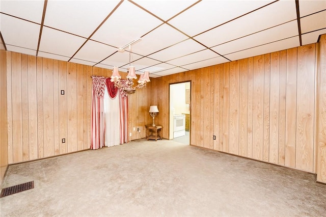 314 N 9th St, Apollo Boro, PA 15613 - empty room with carpet flooring, a chandelier, wooden walls, and a paneled ceiling