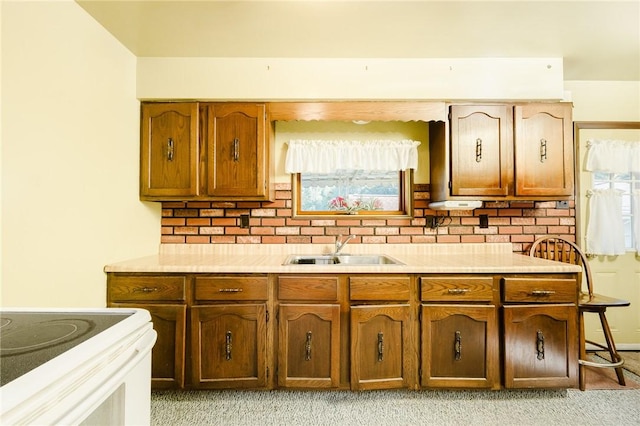 314 N 9th St, Apollo Boro, PA 15613 - kitchen with light countertops, decorative backsplash, light colored carpet, and brown cabinets