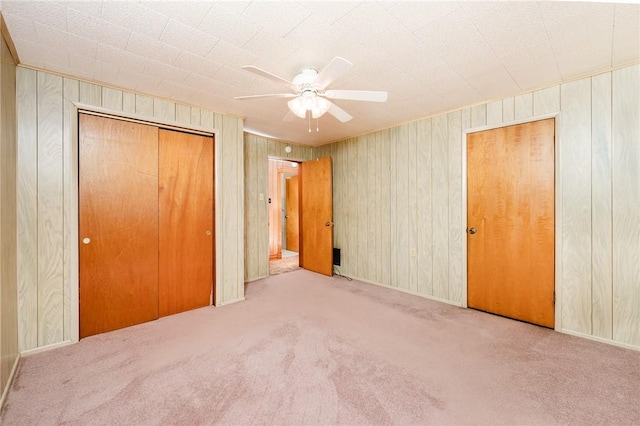 314 N 9th St, Apollo Boro, PA 15613 - unfurnished bedroom with carpet, wooden walls, and a ceiling fan