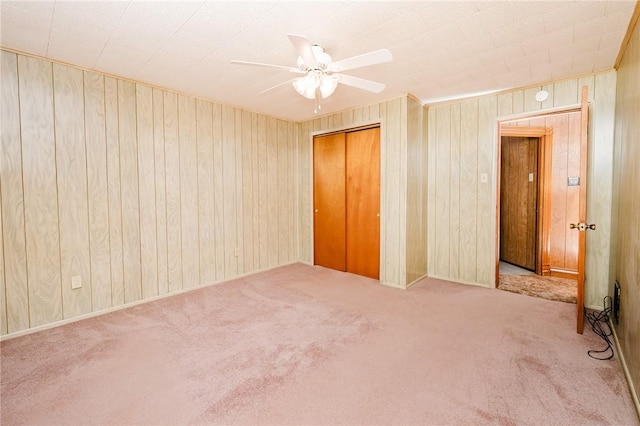 314 N 9th St, Apollo Boro, PA 15613 - unfurnished bedroom with carpet, wood walls, a closet, and ceiling fan