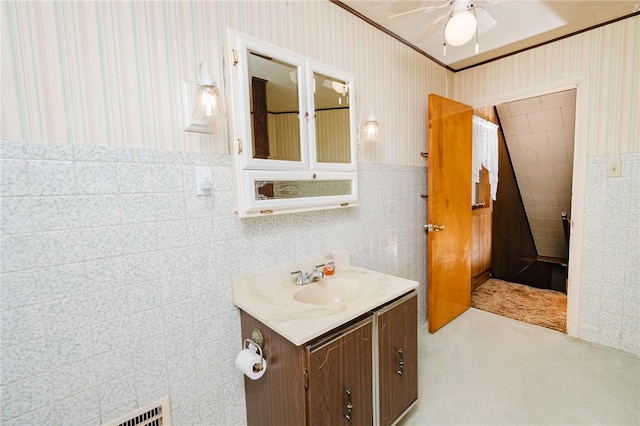 314 N 9th St, Apollo Boro, PA 15613 - bathroom with vanity, ceiling fan, tile walls, and wallpapered walls