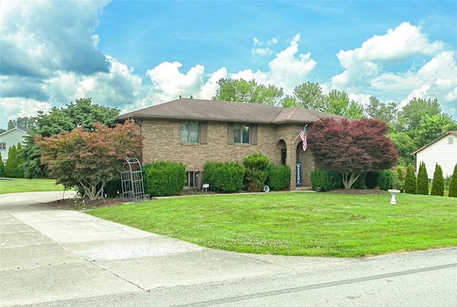 334 Park St, North Union Twp, PA 15401 - view of front facade with a front yard, brick siding, and concrete driveway