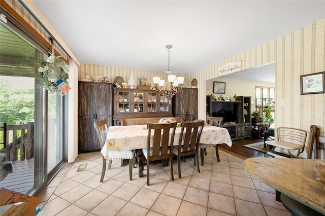 334 Park St, North Union Twp, PA 15401 - dining room with wallpapered walls, a chandelier, and light tile patterned flooring