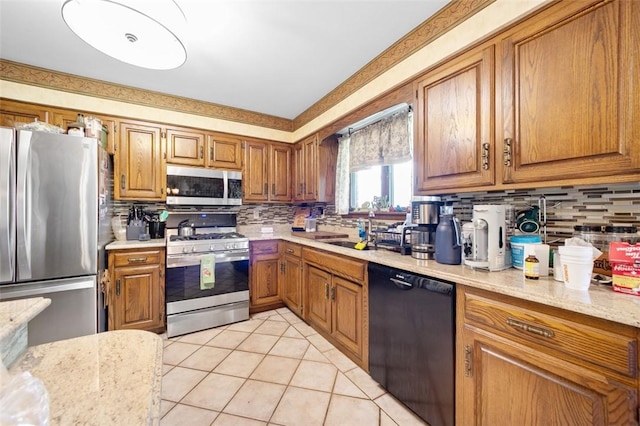 334 Park St, North Union Twp, PA 15401 - kitchen with stainless steel appliances, backsplash, and brown cabinets
