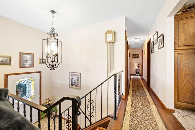 334 Park St, North Union Twp, PA 15401 - corridor with an upstairs landing, light wood-style floors, attic access, and a chandelier