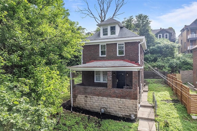 1462 Elm St, Wilkinsburg, PA 15221 - american foursquare style home featuring brick siding, covered porch, and roof with shingles