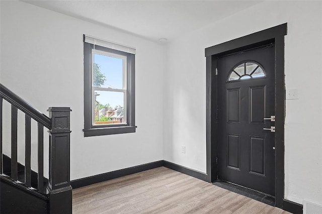 1462 Elm St, Wilkinsburg, PA 15221 - entrance foyer with wood finished floors, healthy amount of natural light, and stairway