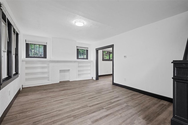 1462 Elm St, Wilkinsburg, PA 15221 - unfurnished living room featuring wood finished floors and baseboards