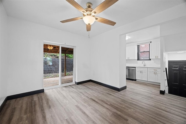 1462 Elm St, Wilkinsburg, PA 15221 - unfurnished living room with light wood-style floors and a ceiling fan