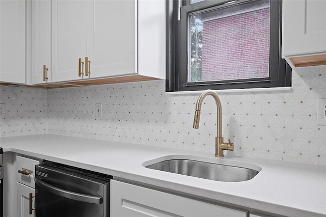 1462 Elm St, Wilkinsburg, PA 15221 - kitchen featuring stainless steel dishwasher, light countertops, white cabinetry, and decorative backsplash