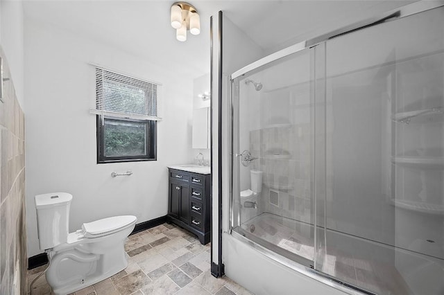 1462 Elm St, Wilkinsburg, PA 15221 - bathroom featuring vanity, stone finish flooring, and combined bath / shower with glass door