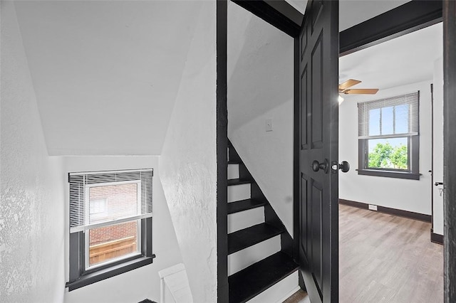 1462 Elm St, Wilkinsburg, PA 15221 - staircase with a textured wall, wood finished floors, and a ceiling fan