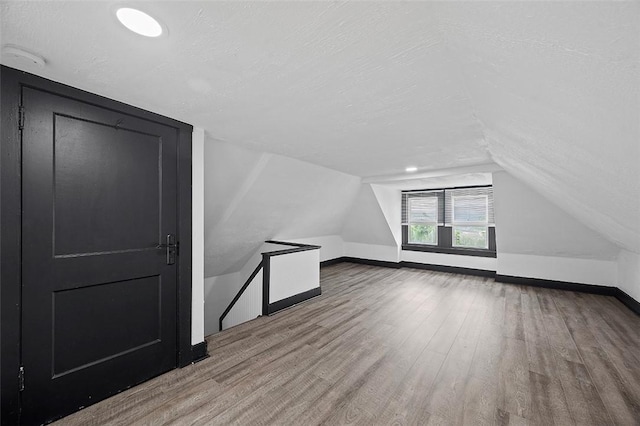 1462 Elm St, Wilkinsburg, PA 15221 - bonus room with wood finished floors, a textured ceiling, and lofted ceiling