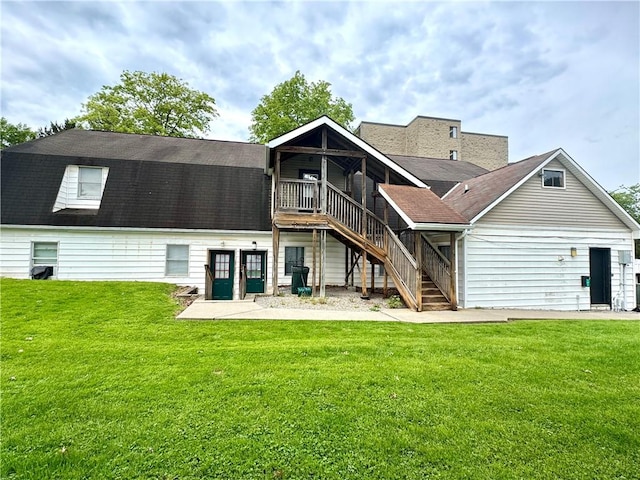 230 E Water St, Slippery Rock Boro, PA 16057 - back of property featuring stairway, a wooden deck, a lawn, and roof with shingles