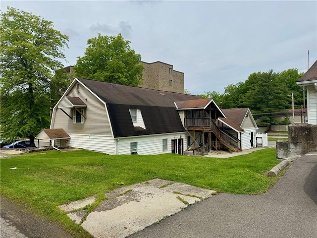 230 E Water St, Slippery Rock Boro, PA 16057 - back of property featuring stairs, a lawn, a gambrel roof, a shingled roof, and a chimney