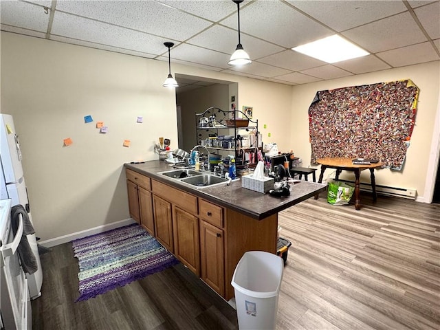 230 E Water St, Slippery Rock Boro, PA 16057 - bar featuring a paneled ceiling, wood finished floors, a baseboard heating unit, stove, and hanging light fixtures