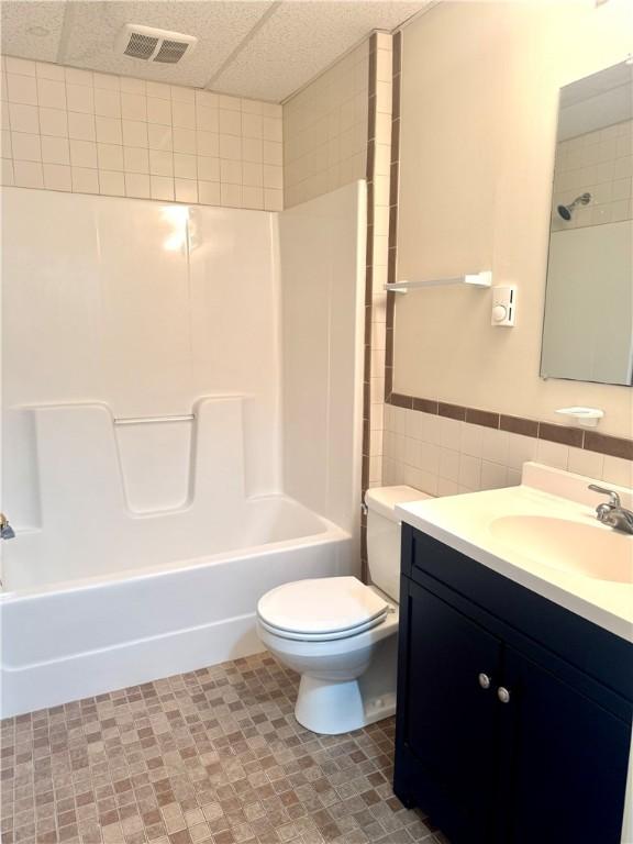 230 E Water St, Slippery Rock Boro, PA 16057 - full bath with vanity, shower / bath combination, and tile walls