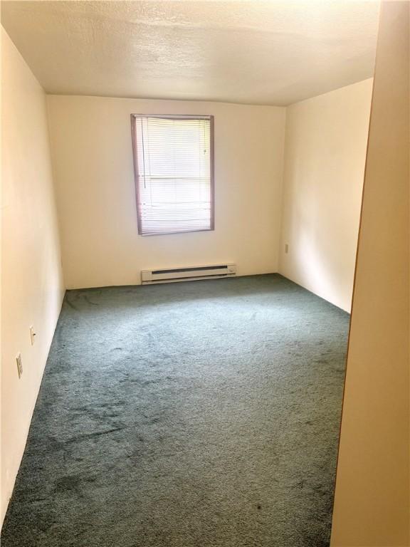 230 E Water St, Slippery Rock Boro, PA 16057 - unfurnished room with a baseboard radiator and carpet floors