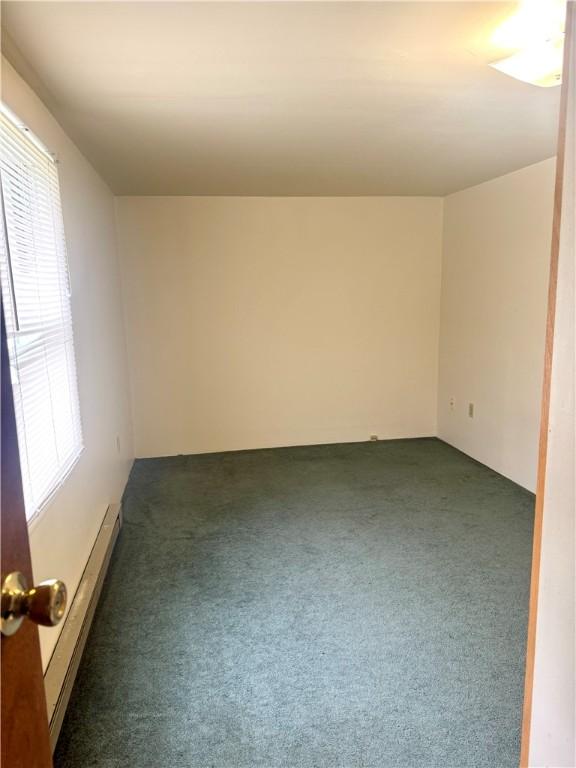 230 E Water St, Slippery Rock Boro, PA 16057 - carpeted spare room featuring plenty of natural light and a baseboard radiator
