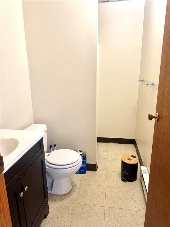 230 E Water St, Slippery Rock Boro, PA 16057 - bathroom featuring vanity, tile patterned flooring, baseboard heating, and a shower