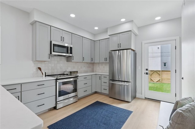 1211 Boyle St, Central North Side, PA 15212 - kitchen with stainless steel appliances, gray cabinets, light wood-type flooring, decorative backsplash, and recessed lighting
