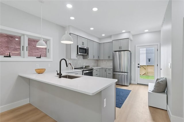 1211 Boyle St, Central North Side, PA 15212 - kitchen with appliances with stainless steel finishes, gray cabinetry, light countertops, light wood-style floors, and recessed lighting