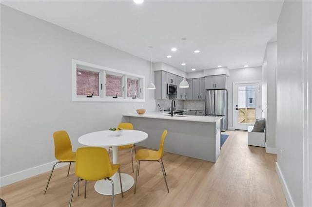 1211 Boyle St, Central North Side, PA 15212 - kitchen with stainless steel appliances, gray cabinetry, light countertops, light wood-style flooring, and recessed lighting