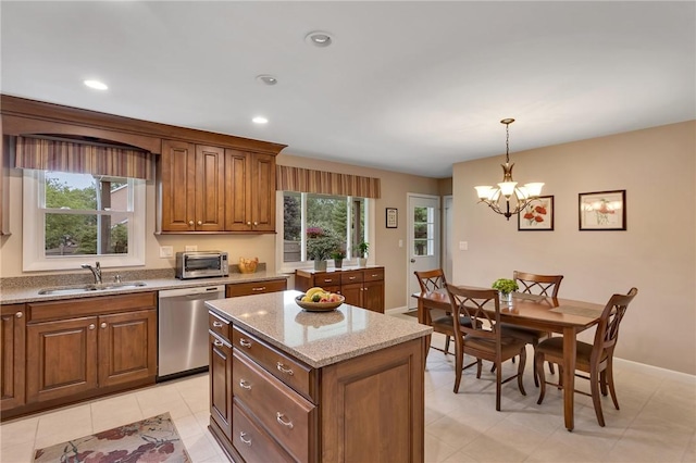 2899 E Elfinwild Rd, Hampton, PA 15101 - kitchen featuring dishwasher, brown cabinetry, a chandelier, hanging light fixtures, and light stone countertops