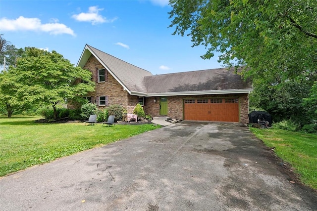 362 Ridge Rdg, Jackson Twp, PA 16063 - view of front of house with an attached garage, a front lawn, asphalt driveway, a shingled roof, and brick siding
