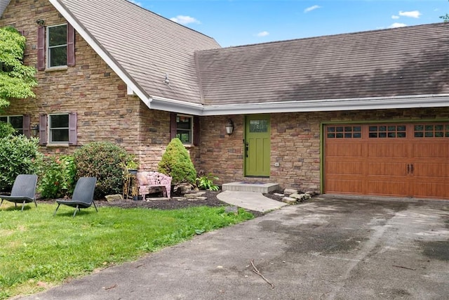 362 Ridge Rdg, Jackson Twp, PA 16063 - view of front of property with a garage, stone siding, asphalt driveway, and a front yard