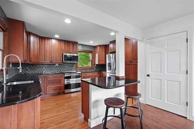362 Ridge Rdg, Jackson Twp, PA 16063 - kitchen with appliances with stainless steel finishes, light wood-style flooring, tasteful backsplash, dark countertops, and recessed lighting
