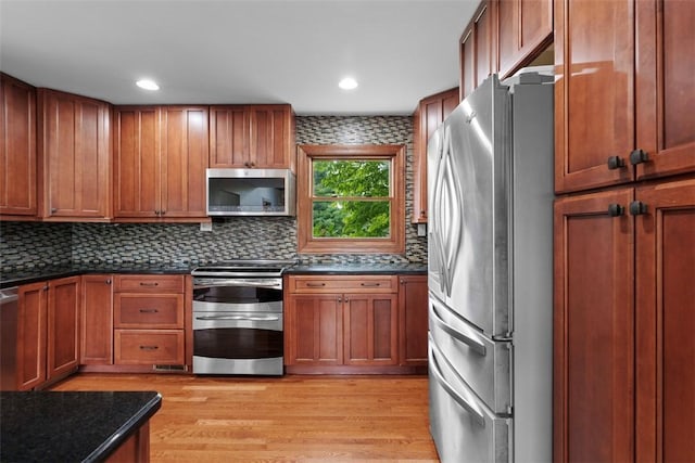 362 Ridge Rdg, Jackson Twp, PA 16063 - kitchen with appliances with stainless steel finishes, light wood finished floors, decorative backsplash, brown cabinetry, and recessed lighting