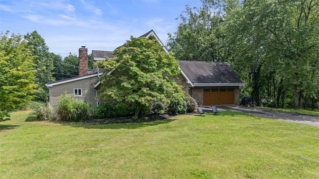 362 Ridge Rdg, Jackson Twp, PA 16063 - view of home's exterior with asphalt driveway, a chimney, a lawn, and an attached garage