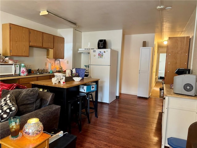 250 E Water St, Slippery Rock Boro, PA 16057 - kitchen with white appliances, dark wood finished floors, light countertops, and brown cabinets