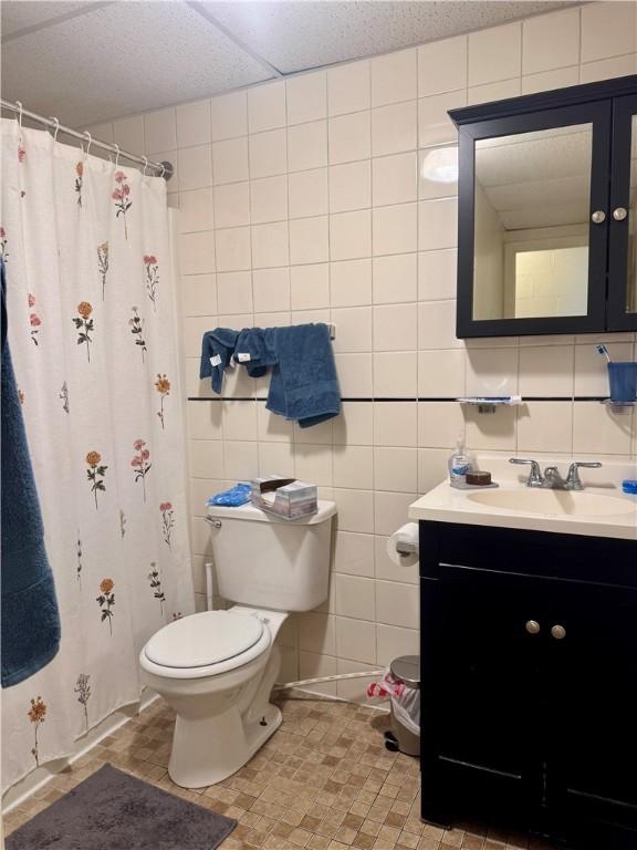 250 E Water St, Slippery Rock Boro, PA 16057 - full bathroom with vanity, a shower with curtain, and tile walls