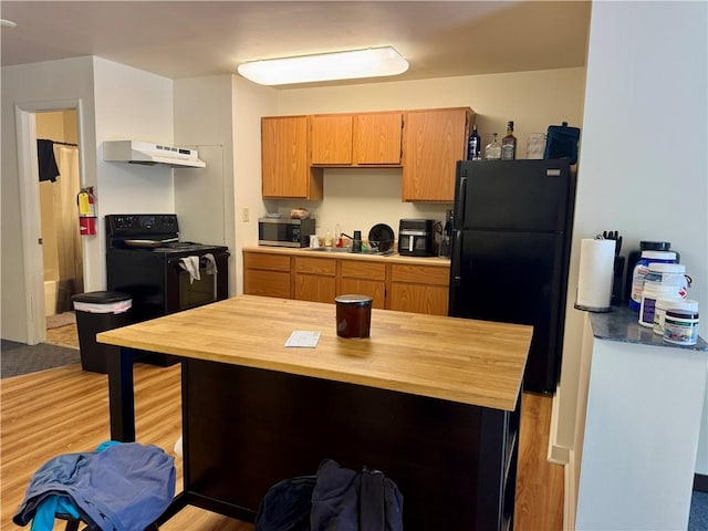 250 E Water St, Slippery Rock Boro, PA 16057 - kitchen featuring black appliances, exhaust hood, butcher block counters, and light wood-style flooring