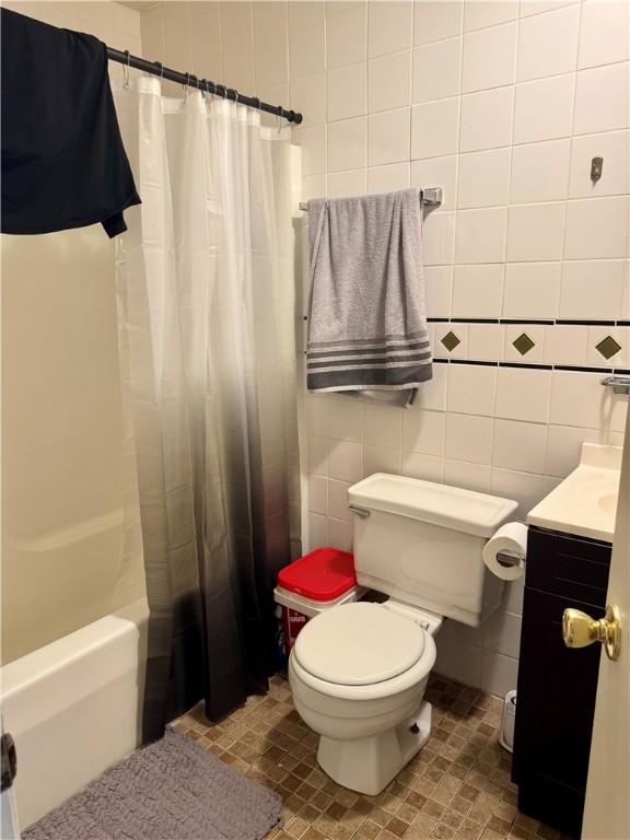 250 E Water St, Slippery Rock Boro, PA 16057 - bathroom with vanity, shower / bath combo with shower curtain, tile patterned flooring, and tile walls
