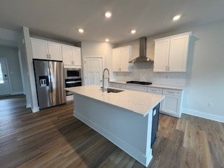 326 Stately Ct, Adams Twp, PA 16046 - kitchen featuring appliances with stainless steel finishes, wall chimney exhaust hood, a center island with sink, dark wood-style flooring, and light countertops