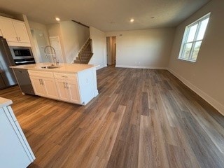 326 Stately Ct, Adams Twp, PA 16046 - kitchen featuring stainless steel microwave, white cabinets, dark wood-style flooring, open floor plan, and light countertops
