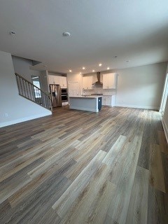 326 Stately Ct, Adams Twp, PA 16046 - unfurnished living room with dark wood-type flooring, recessed lighting, and stairs