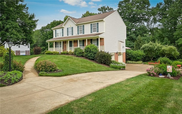 489 Jenny Dr, Richland, PA 15044 - view of front facade with brick siding, driveway, a garage, a front lawn, and covered porch